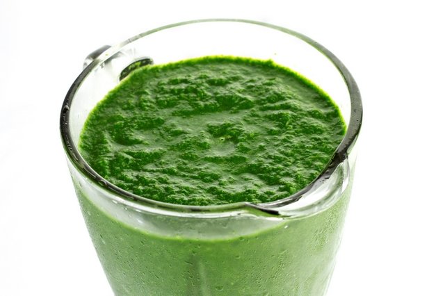A jar of blended spinach